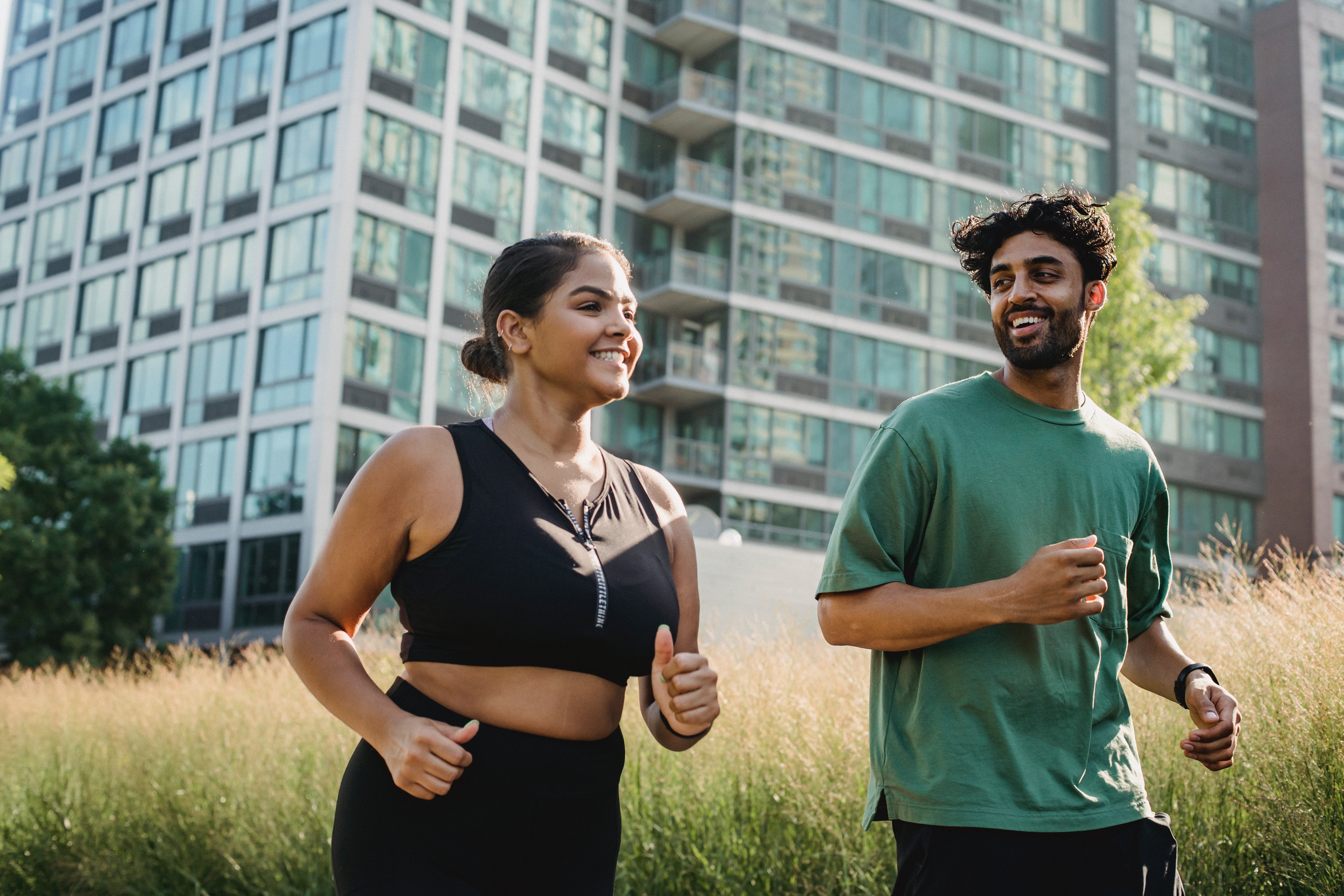 Female and male running on waterfront trail 